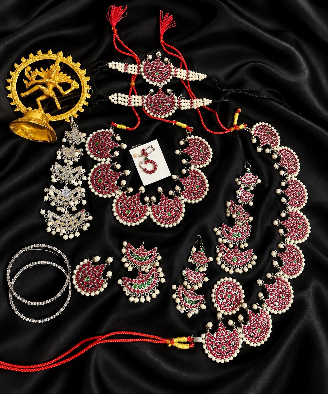 Traditional Indian layered kemp-stone and pearl multi-tier haram necklace with ruby and green stone accents.